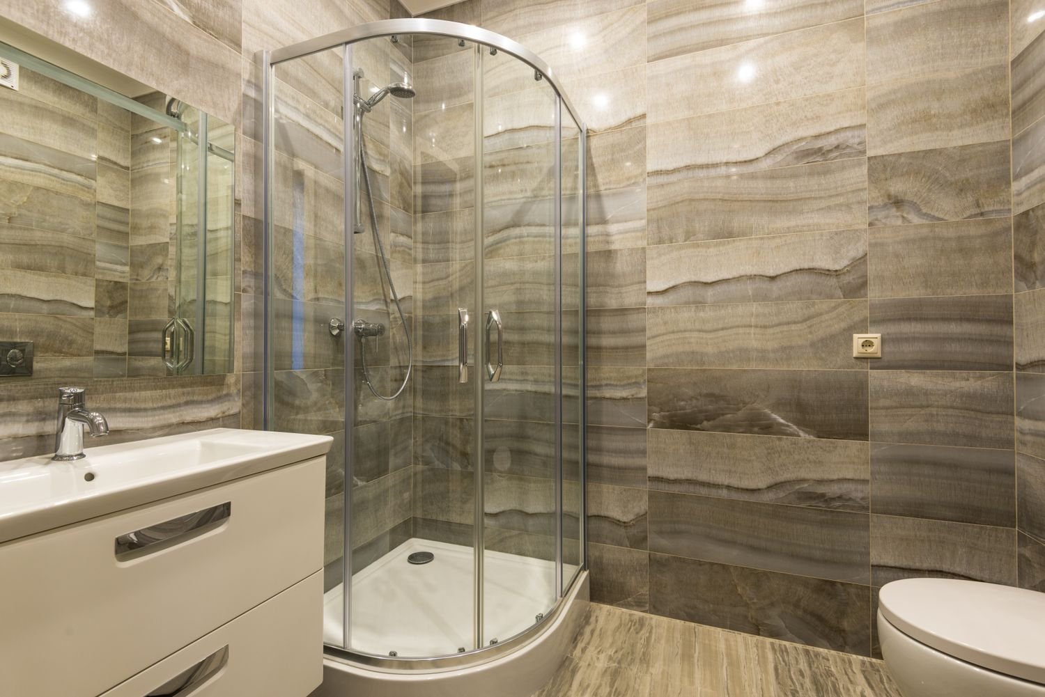 Finished bathroom with a glass shower enclosure and vanity