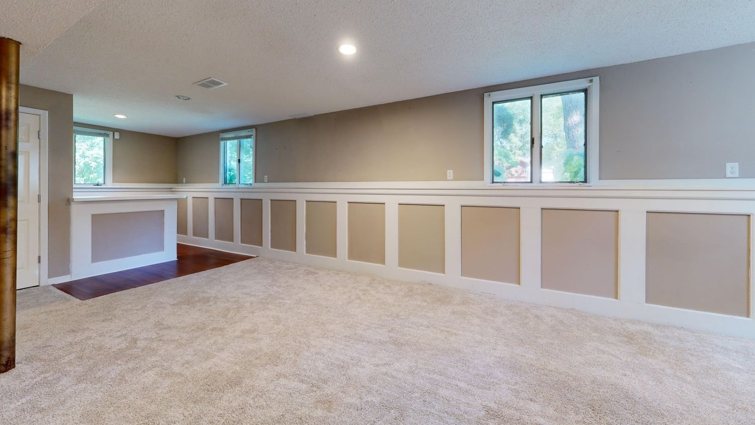 Bright finished basement with natural light and modern furnishings