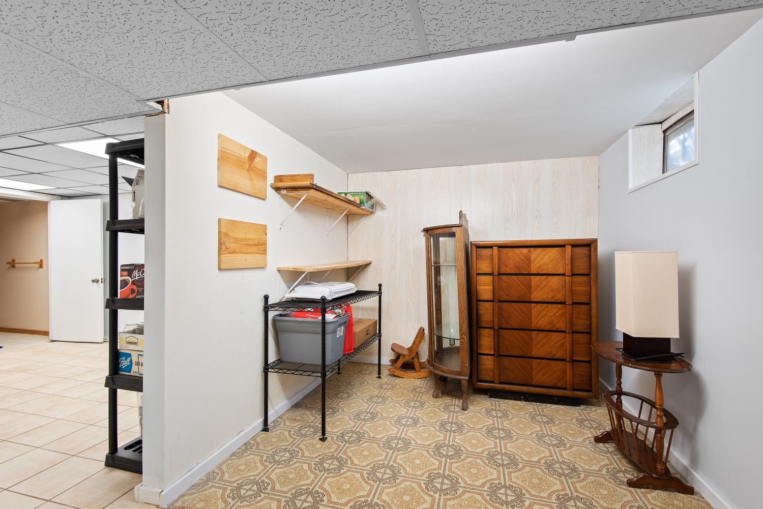 Basement family room with wood furniture and built-in shelving