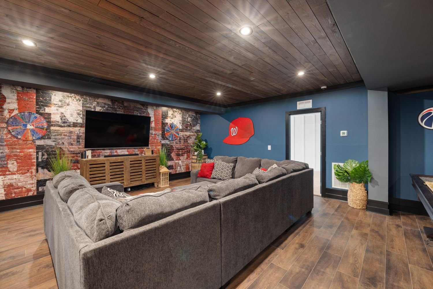 Basement living room with a large sectional couch and television