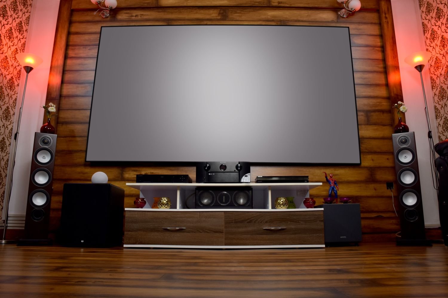 Basement home theater with a large screen and tiered seating
